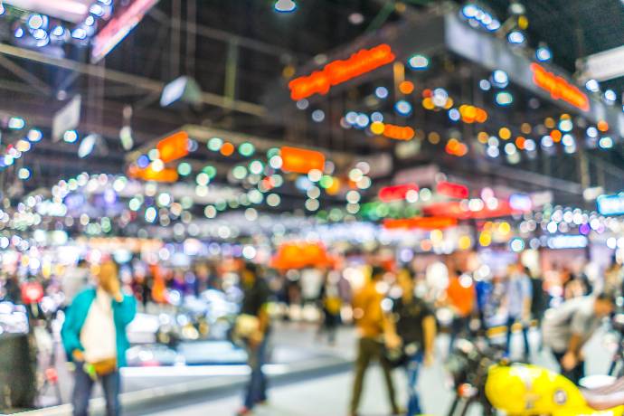 Abstract blurred background image with bokeh light of crowd people at cars exhibition show